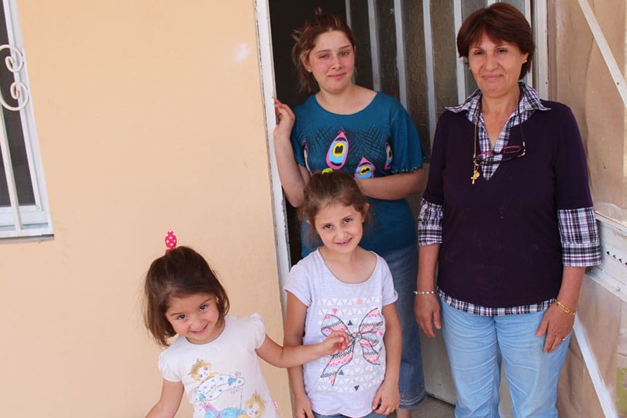 Huda and family outside their home