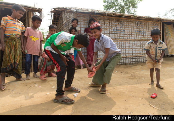 Children playing cricket with flip flop