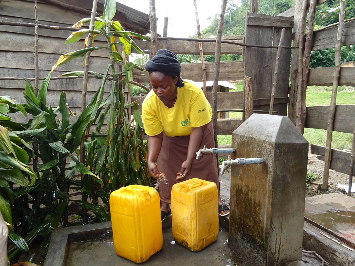 Sifa collects water in Kalehe
