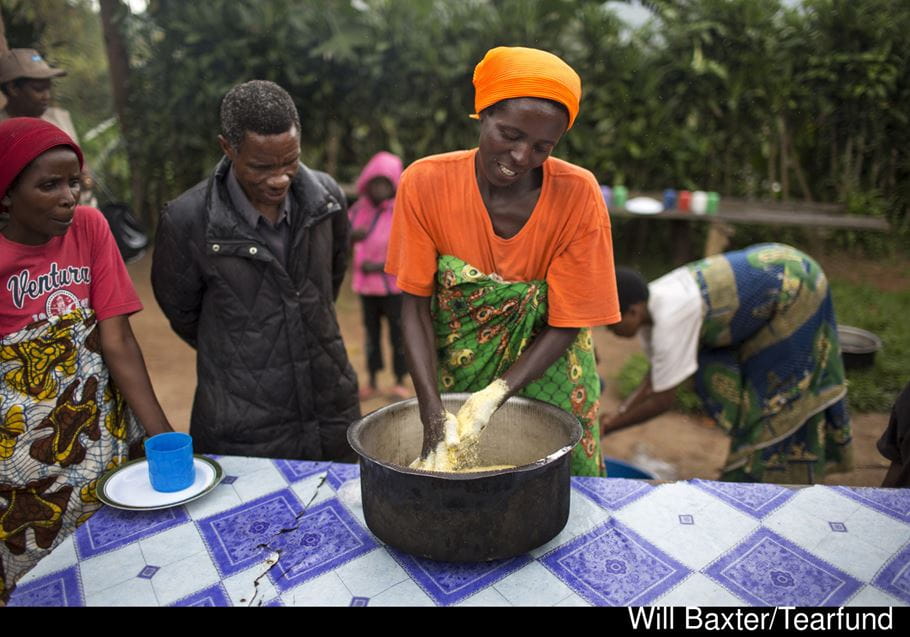 Mother demonstrates making food in Burundi. Will Baxter, Tearfund.
