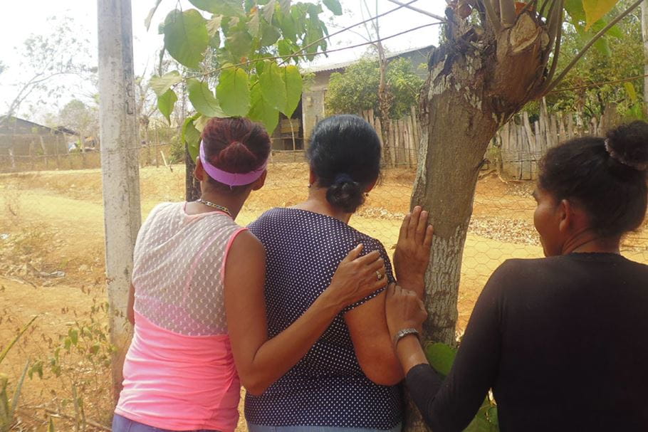SGBV survivors outside, arms around each other