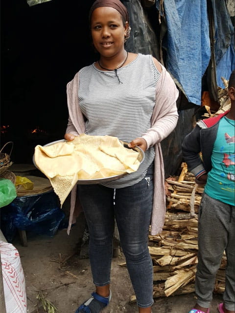 Siret with a plate of injera