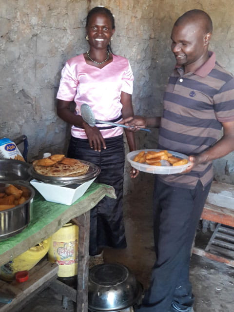 Mary and her husband preparing food