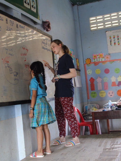 Grace at the whiteboard with pupil