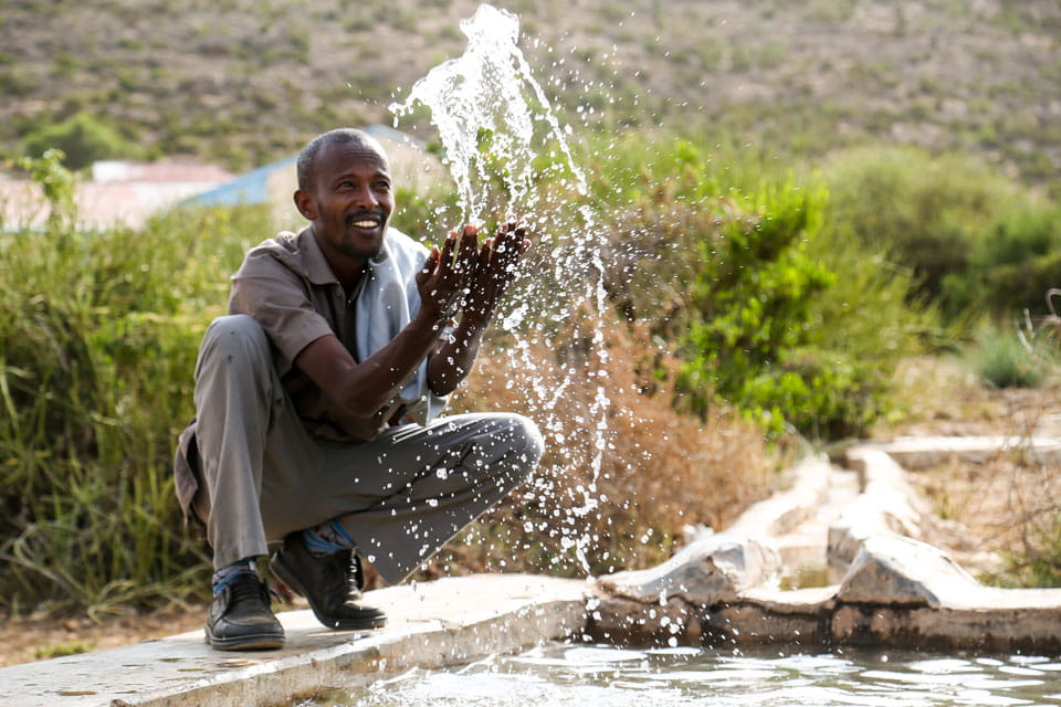 Man by fresh water reservoir