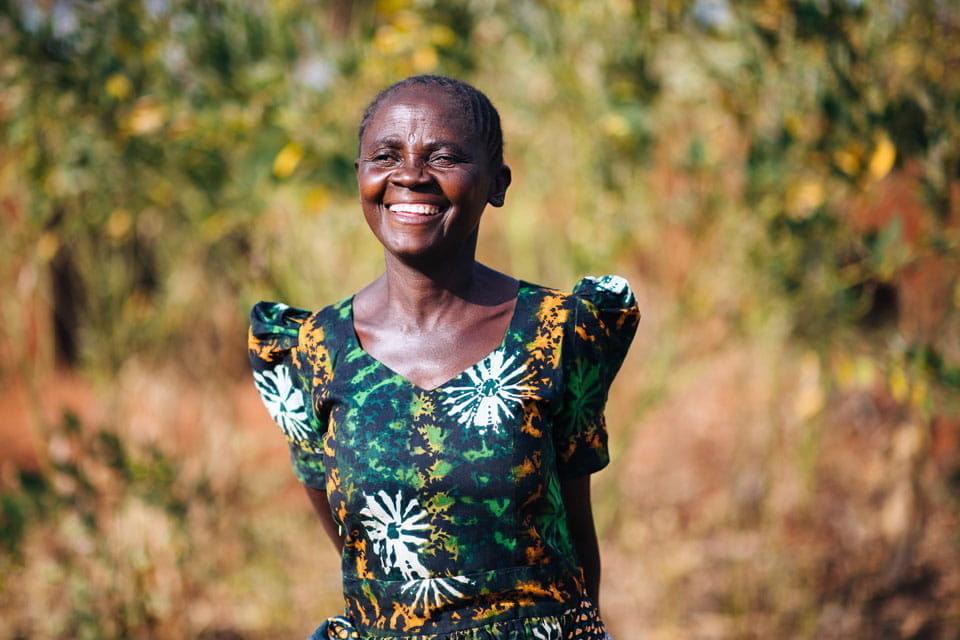 Aksa, smiling with arms behind her back.