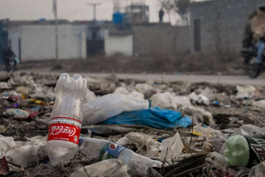 Coke bottle in piles of waste