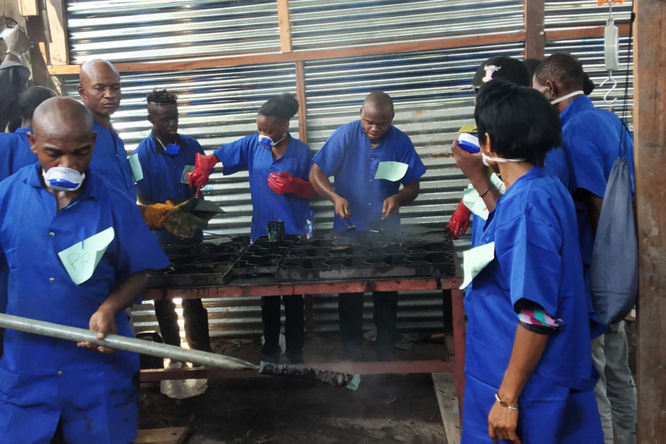 Workers making the recycled tiles