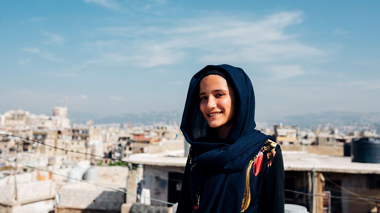 A young girl stands on the roof of her home in Beirut, Lebanon. Credit: Ruth Towell/Tearfund