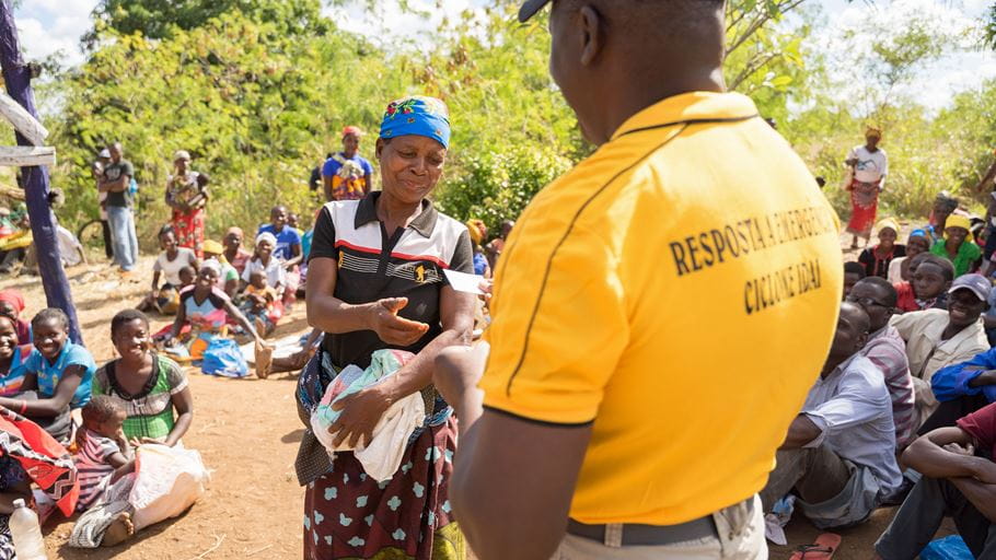 A community member receives a voucher for food during an aid distribution following Cyclone Idai in Mozambique. Credit: David Mutua/Tearfund