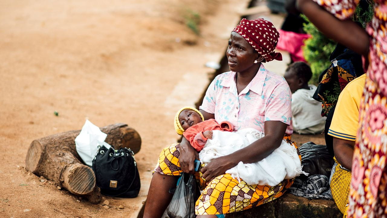A woman sits with her baby at a camp for internally displaced people in Nigeria | Credit: Ruth Towell/Tearfund