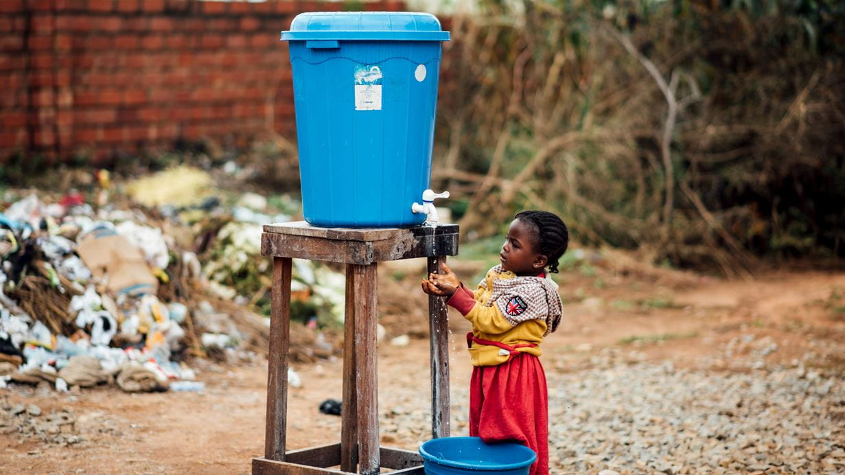 A child washes their hands at a camp for internally displaced people in Nigeria. Credit: Ruth Towell/ Tearfund