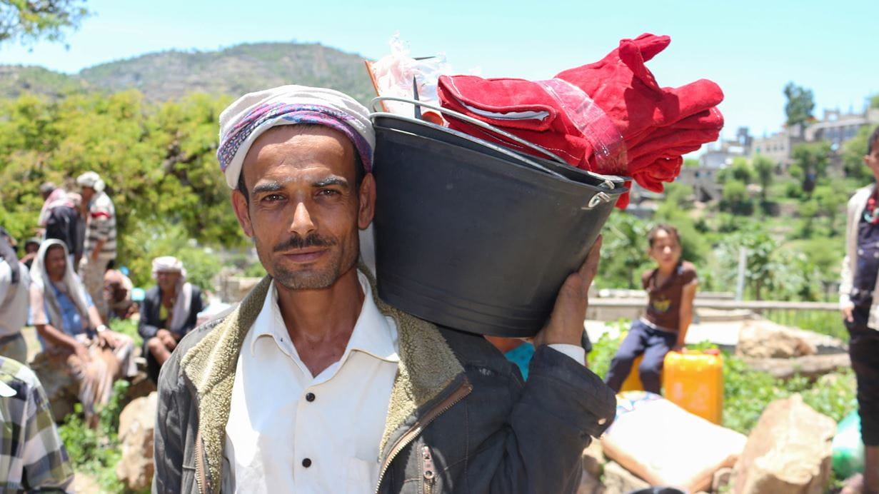 Man carrying bucket of food