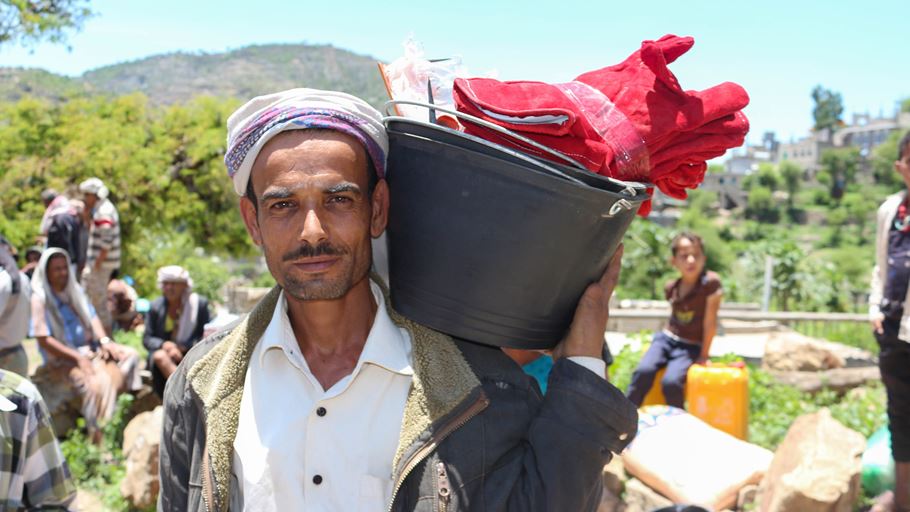 Man carrying bucket of food