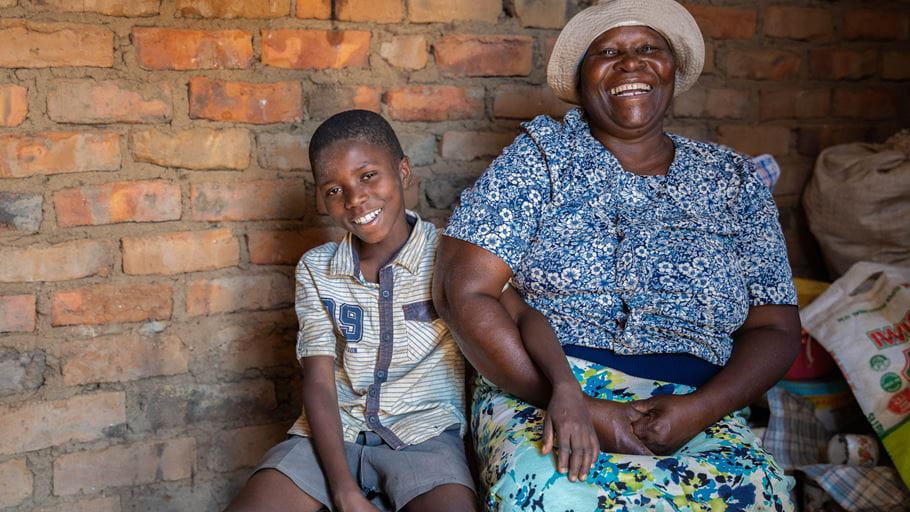 Woman and her grandson sat in chairs and laughing