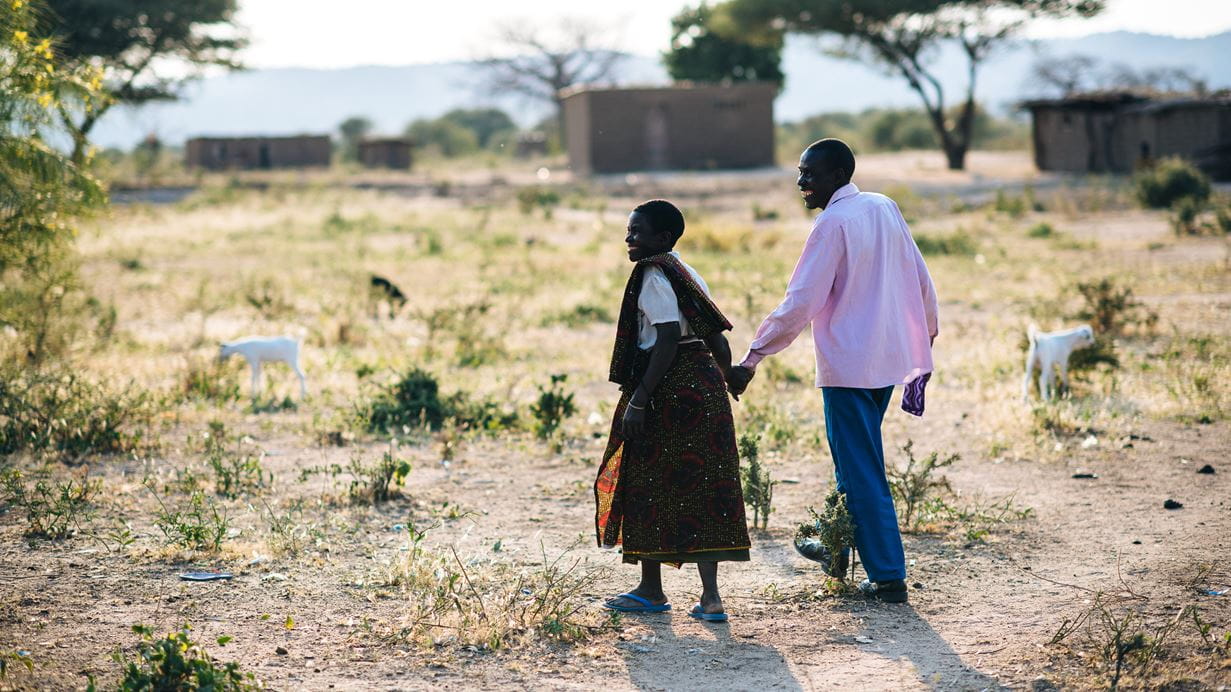 Photo of couple walking and smiling