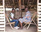 Two men sitting in chairs facing eachother