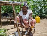 A woman washing a metal plate