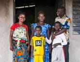 A smiling family standing in a doorway