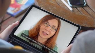 Person watching Katharine Hayhoe film on tablet