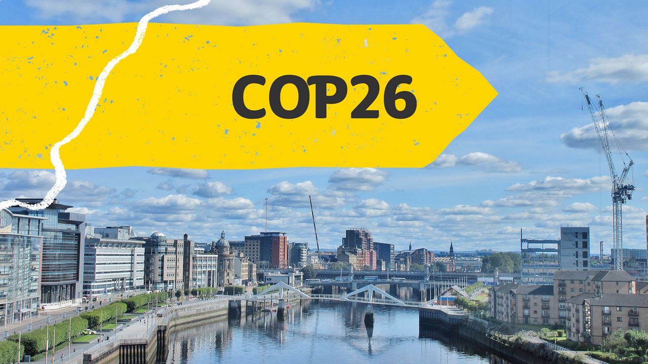 COP26 banner, featuring Glasgow city (Unsplash/Adam Marikar)