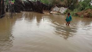 A child walking through flood waters