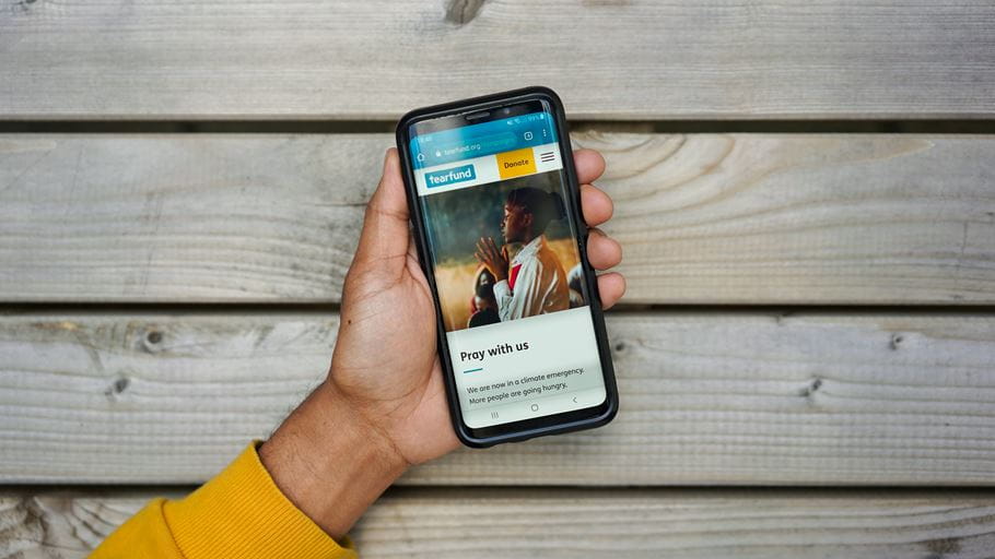 Phone showing the Tearfund prayer for the climate webpage (Kiran Rai / Tearfund)