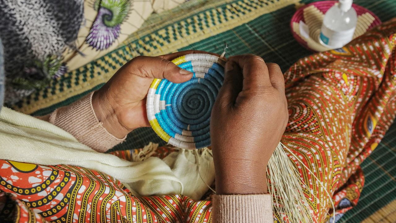 Someone handcrafting a decorative basket