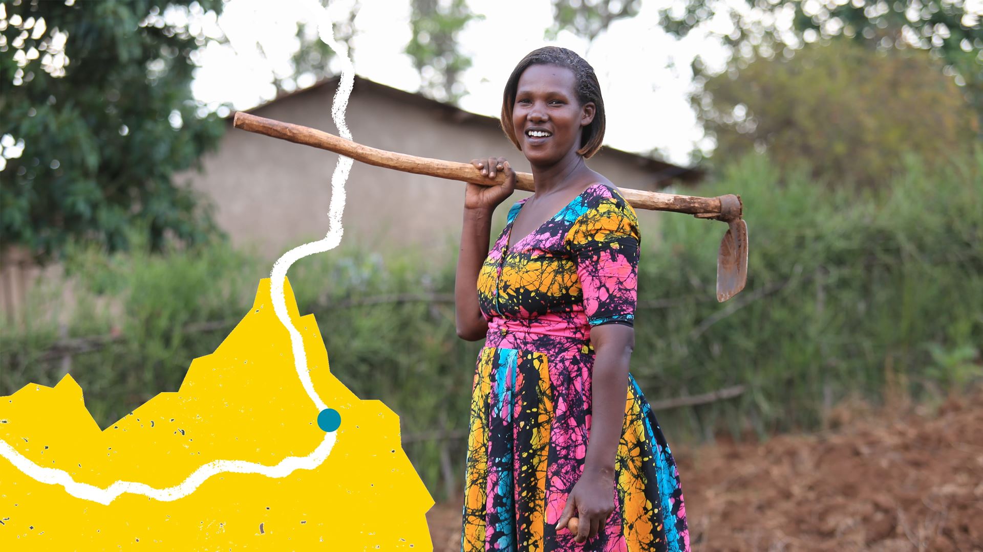 Woman standing holding a farming tool