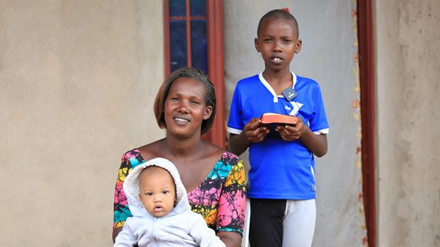 A woman with a baby and a child