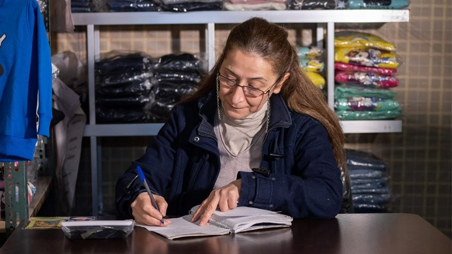 Photo of Ousanna working on her business. 
