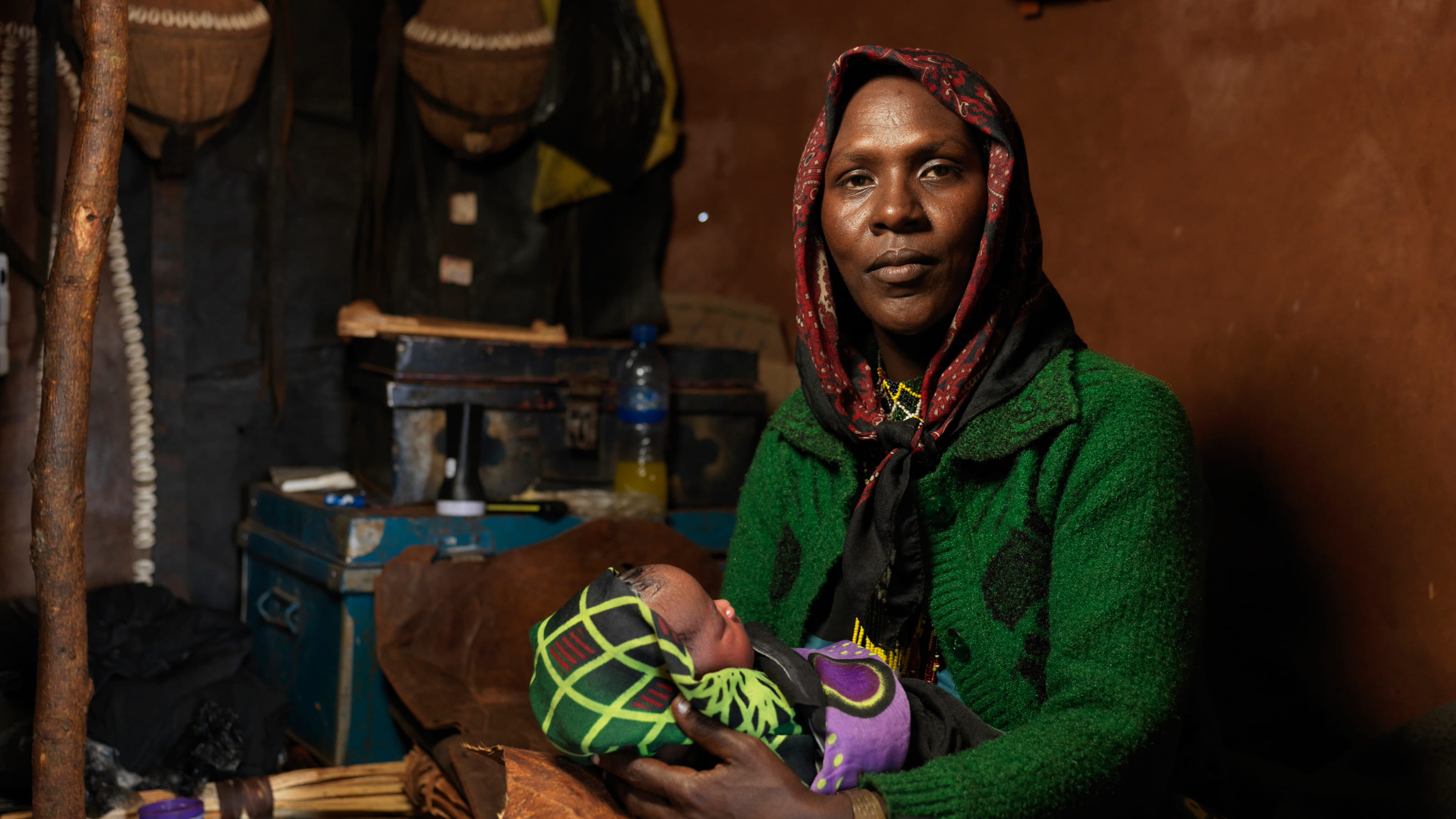 A woman holds a baby in her arms.