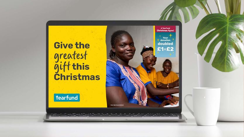 Laptop shows Tearfund Christmas appeal with the message "Give the greatest gift this Christmas".