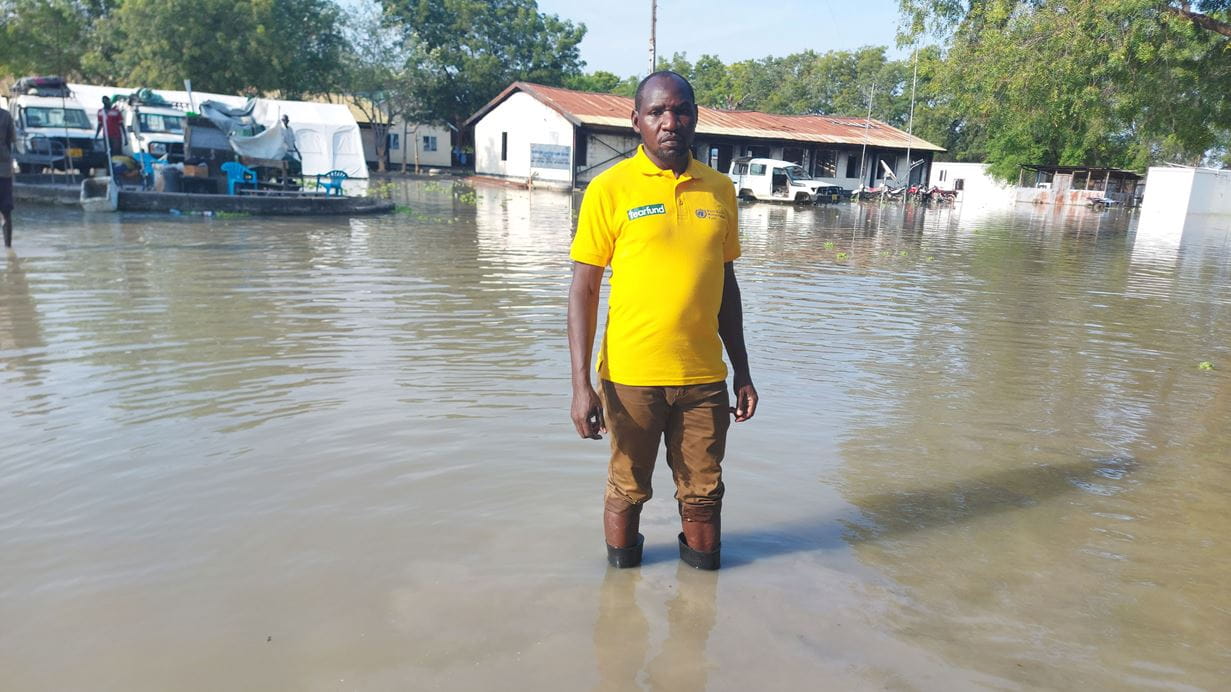 Tearfund staff member stands in flood water in South Sudan.