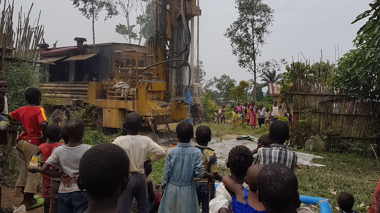 Children gather to watch as drilling the borehole begins | Credit: Tearfund