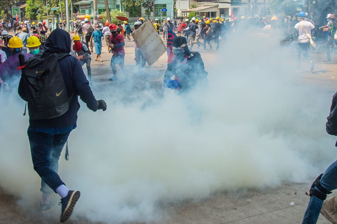 Police crack down on the crowd with tear gas protesters in Yangon, Myanmar (credit: Maung Nyan/Shutterstock)