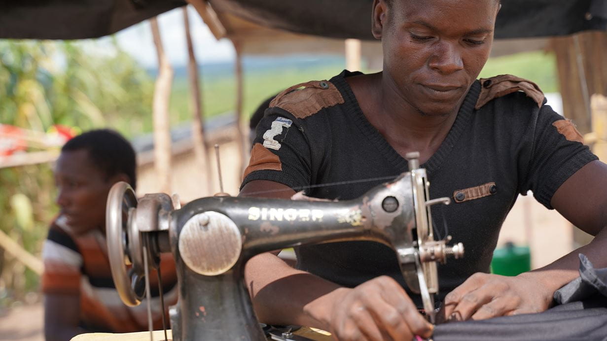 Joachim, who fled the violence with his young family, has been using his sewing machine to make face masks for people in the camps where he now lives | Credit: Stewart Muchapera/Tearfund