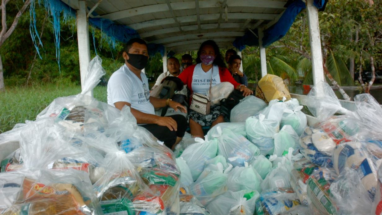 Pastor Hugo delivering food packages to those in need