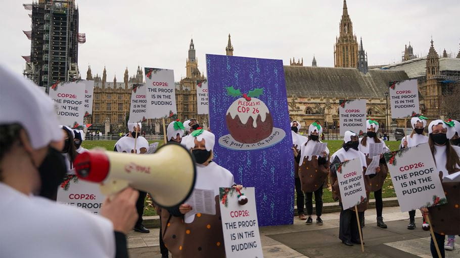 Protesters in parliament square with a giant Christmas card for Boris Johnson (Tearfund)