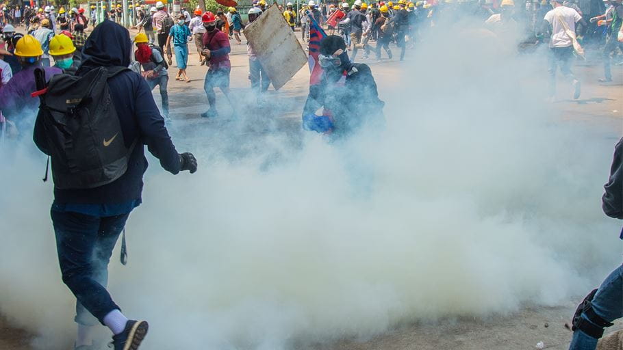 Police crack down on a crowd of protesters with tear gas in Yangon, Myanmar. Credit: Maung Nyan/Shutterstock
