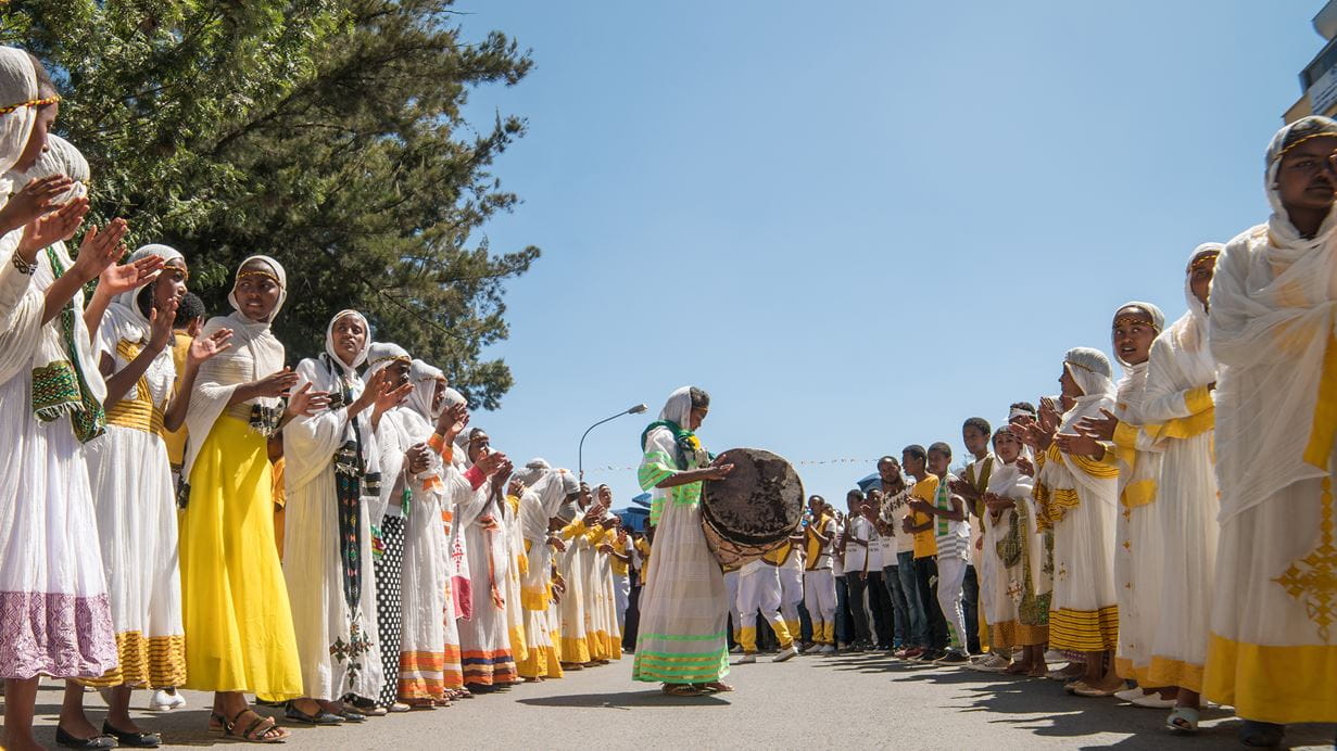 Clergy accompany the singing and chanting of Ethiopian Orthodox followers with kebero, traditional drum, during Timket celebrations in Addis Ababa, Ethiopia | Credit: Dereje/Shutterstock