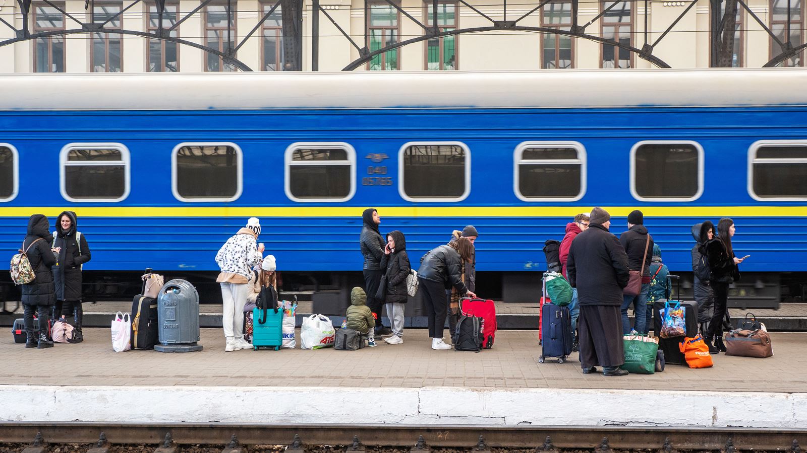 People gather at a train station in Ukraine.