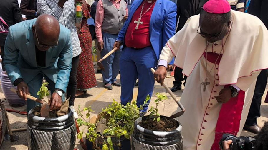 Church leaders using gardening tools