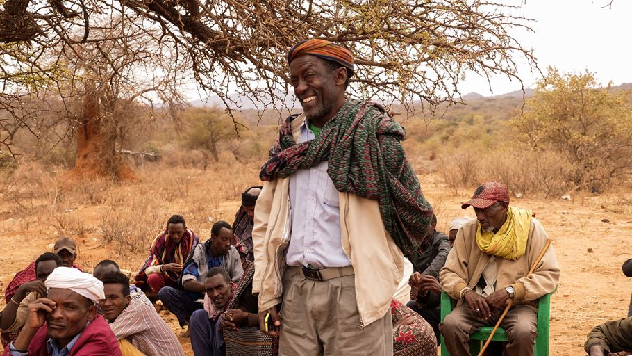 A group of people outside in a dry landscape