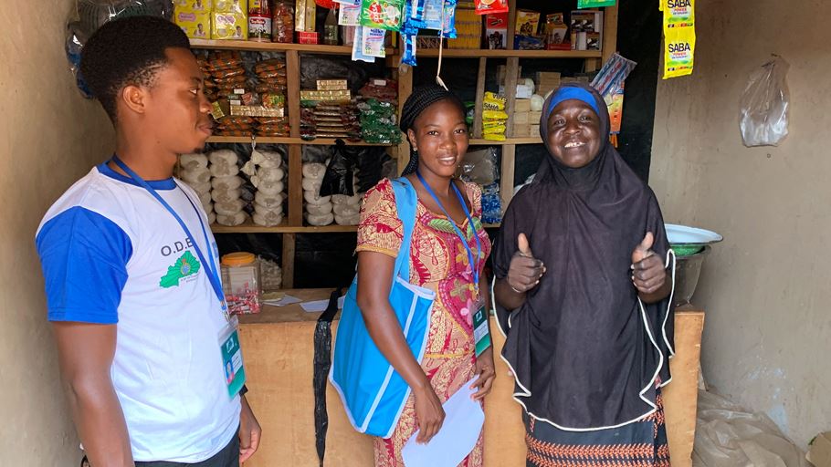 Two women smiling inside a shop.