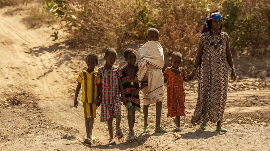 A mother and her five children walking through a dried up riverbed in in Afar, Ethiopia