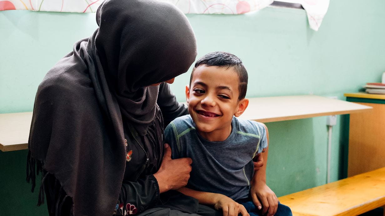 An adult sitting with a child