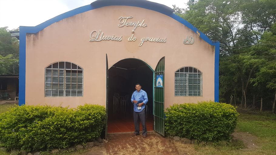 A man standing outside a church building