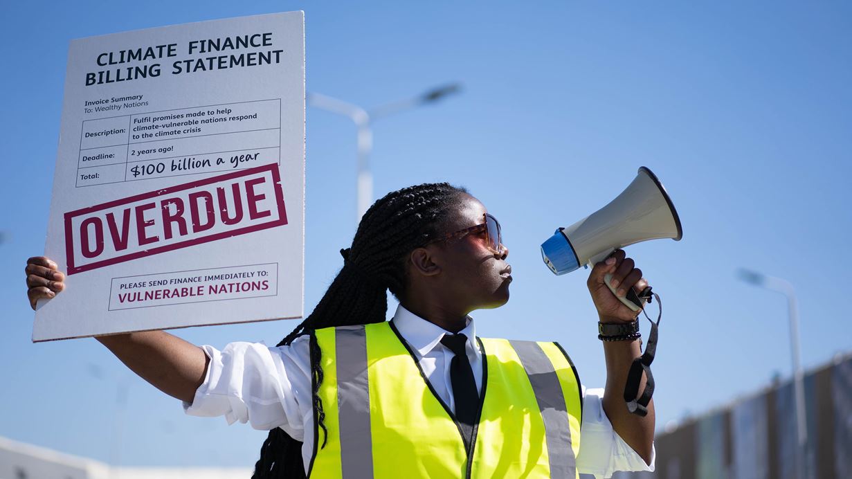 Jessica at the UN Climate Conference in Egypt speaking into a megaphone.