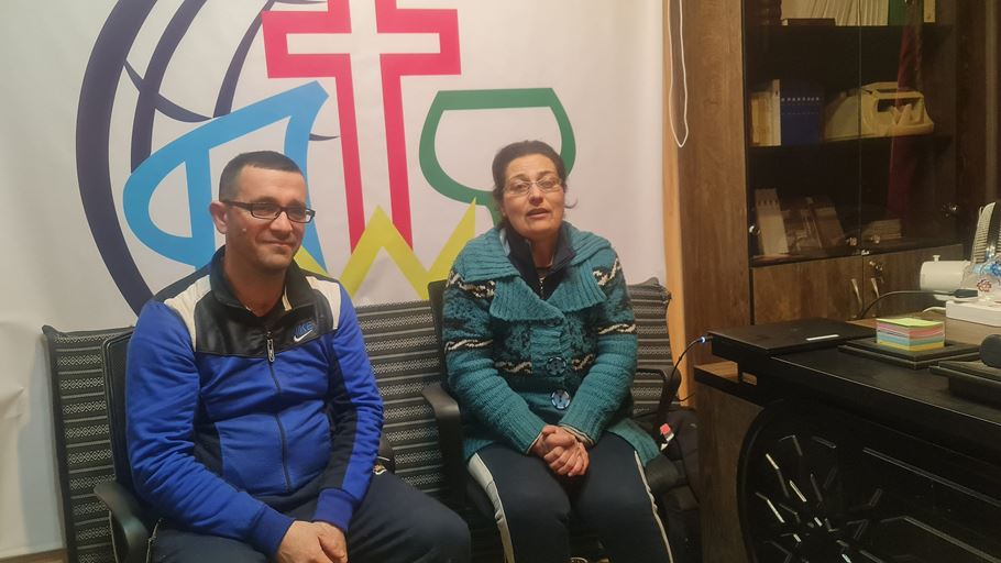 Two people sat on chairs in a church building